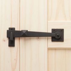 a black door handle on a wooden door