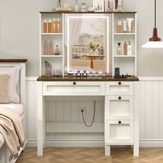 a white desk with lots of bottles on top of it next to a bed in a room