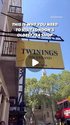 an advertisement for twings tea shop hanging from the side of a building in london