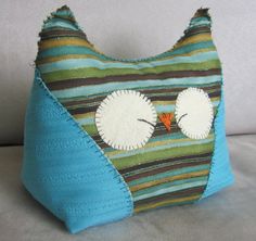 a blue purse with two white eyes on it