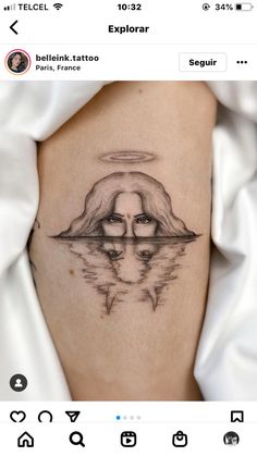 a woman's thigh with an angel tattoo on the side and her reflection in the water