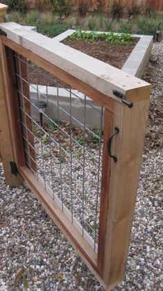 a fenced in area with plants growing out of the top and bottom bars on each side