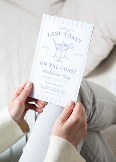 a woman holding up a card that says last toast on the coast