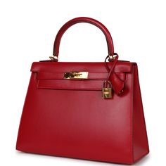 This Kelly, in the Sellier style, is of Rouge Vif tadelakt leather with gold hardware, features tonal stitching, a front toggle closure, a clochette with lock and two keys and a single rolled handle.The interior is lined with Rouge Vif chevre and features one zip pocket with an Hermes engraved pull and two open pockets on the opposite side.Collection: AOrigin: FranceCondition: ; Excellent - This bag retains shape and structure, exterior leather shows marking, interior leather is clean, partial plastic on hardware resulting in moderate scratching and tarnishing.Accompanied by: Hermes box, Hermes dustbag, clochette, lock, two keys, shoulder strapMeasurements: 10" width x 7.5" height x 4.75" depth; 3.5" handle drop (16.5" shoulder strap drop) Hermes Kelly Sellier, Kelly Sellier, Hermes Box, Gold Ounce, Gold Hardware, Bags Women, Fashion Bags, Zip Pockets, Dust Bag