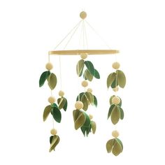 a green and white mobile with leaves hanging from it