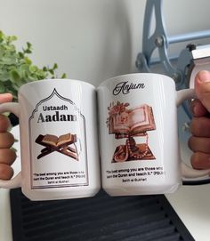 two coffee mugs with the same advertisement on them, one has an open book