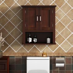 a bathroom with a toilet, sink and cabinet above it's countertop is shown