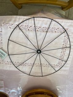 a white table cloth with a wheel on it and other items in front of it