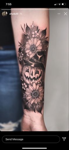 a woman's arm with a skull and flowers tattoo on the left side of her arm