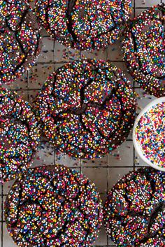 sprinkle covered cookies on a table with a spoon