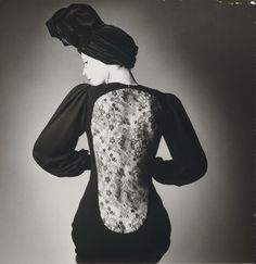 the back of a woman's dress in black and white with flowers on it