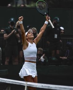 a female tennis player celebrating her victory on the court