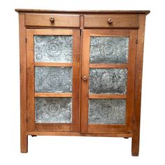 a wooden cabinet with glass doors on the front and side panels that have metal designs on them