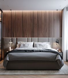 a large bed sitting in the middle of a bedroom next to a tall wooden wall