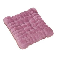 a pink cushion that is on top of a white surface with no one around it