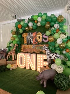 an animal themed birthday party with balloons and decorations