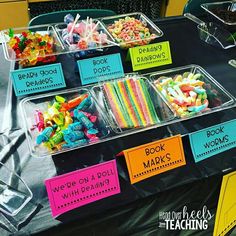 there are many different types of candy on display at the table with signs that say book worms and do it yourself