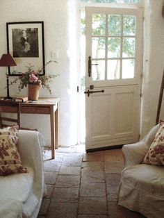 a living room filled with furniture and a white door