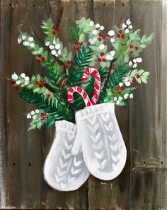 a painting of two white boots with candy canes in them