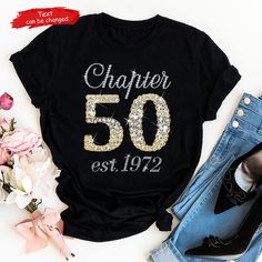 a black shirt with the number 50 on it and some flowers in front of it