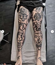 a person with tattoos on their legs laying down