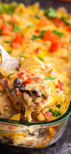 a casserole dish filled with chicken, black beans and veggies is being scooped from the casserole