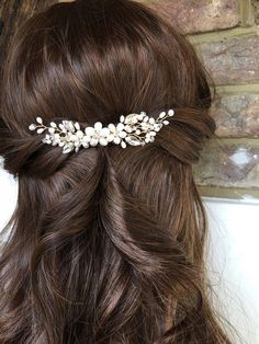 a close up of a woman's hair wearing a bridal headpiece