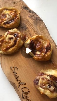 several pastries on a wooden board with writing