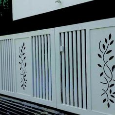 a white fence with decorative designs on it