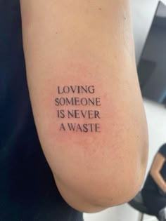 a person with a tattoo on their arm that says loving someone is never a waste