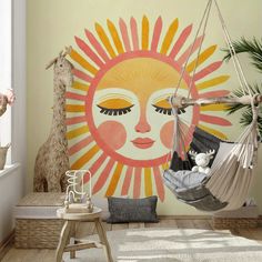 a child's room with a hammock and giraffes on the wall