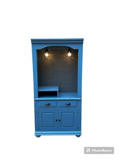 a blue entertainment center with two lights on it's sides and an open shelf