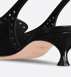 The Dior Boy slingback pump revisits classic codes with a refined touch. The black calfskin upper features perforated details, while the vamp is accented by a gold-tone Christian Dior Paris signature. Finished with an adjustable strap and buckle, a pointed toe and 4-cm (1.5) kitten heel, the pump will complete sophisticated looks.. 39 Denim Swimsuit, Christian Dior Paris, Dior Star, Dior Paris, Icon Shoes, Dior Book Tote, Short Denim, Star Shoes, Backpack Tote Bag