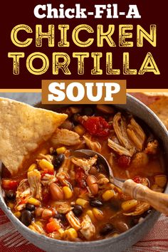 chicken tortilla soup with corn and black beans in a bowl, topped with tortilla chips