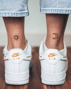 a woman's foot with a tattoo on her left ankle and the word air written in gold ink