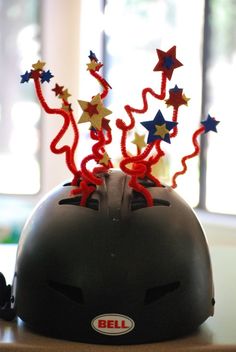 a helmet with red, white and blue stars on it is sitting on a desk