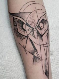 an owl tattoo on the arm with geometric shapes and lines around it's head