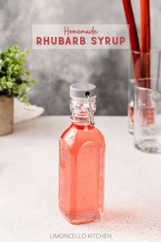 a pink liquid bottle sitting on top of a table