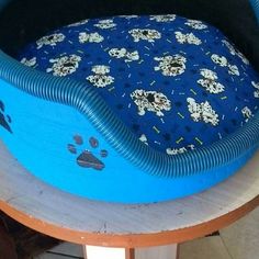 a dog bed made to look like it is floating in the water with paw prints on it