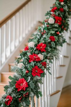 christmas garland with poinsettis and greenery on the bannister rail