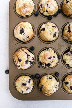 blueberry muffins in a muffin tin ready to be baked into the oven