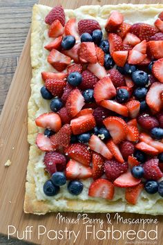 a square pastry topped with strawberries and blueberries