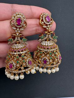 Matte Multi Stone Peacock Jhumki EarringsColor : Matte GoldenSize : Length : 2 Inches; Weight : 11 grams eachStones : CZ Red Green Stones Pearls Jhumki Earrings, Traditional Earrings, Green Stones, Social Events, Multi Stone, Green Stone, Indian Jewelry, Costume Jewelry, Red Green