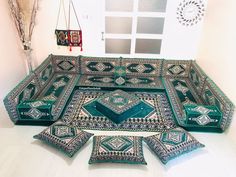 a group of pillows sitting on top of a white floor