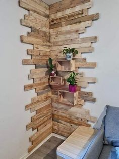 a room that has some wooden pallets on the wall and shelves with plants in them