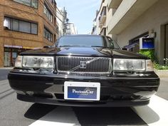 a black car is parked on the street