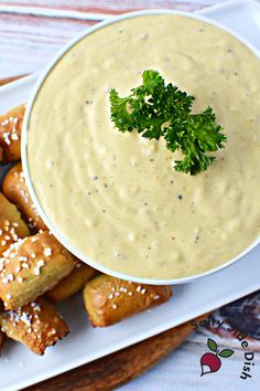 a white plate topped with pretzels and dip