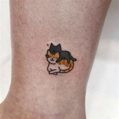 a small tattoo of a cat on the side of a person's leg,