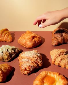 there are many different types of pastries on the table, including croissants