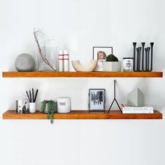 two wooden shelves with pictures and other items on them